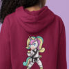girl wearing burgundy hoodie with karate unicorn art