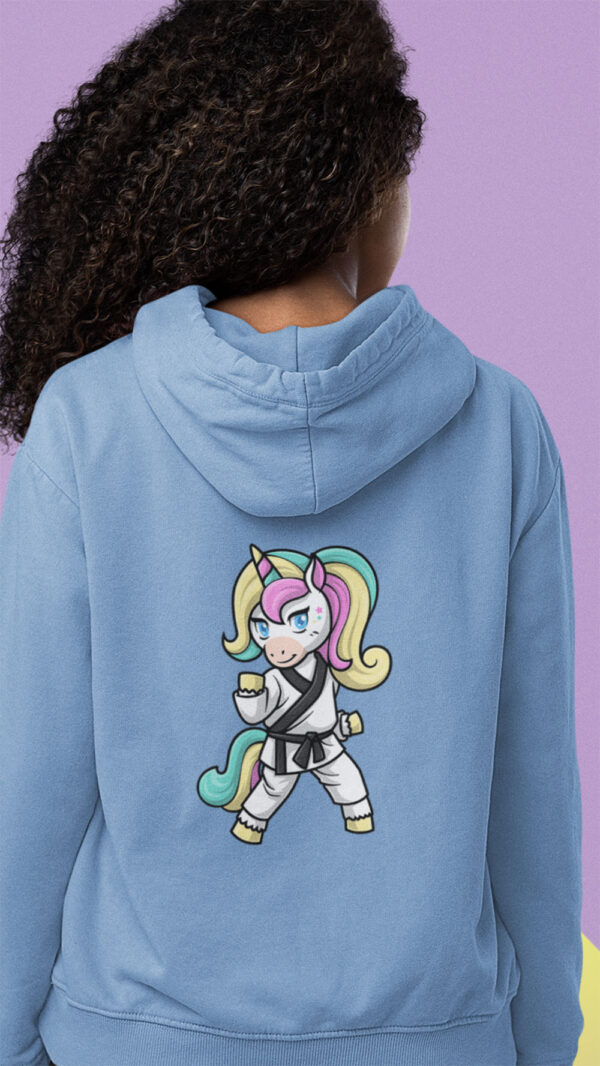 girl wearing blue hoodie with karate unicorn art
