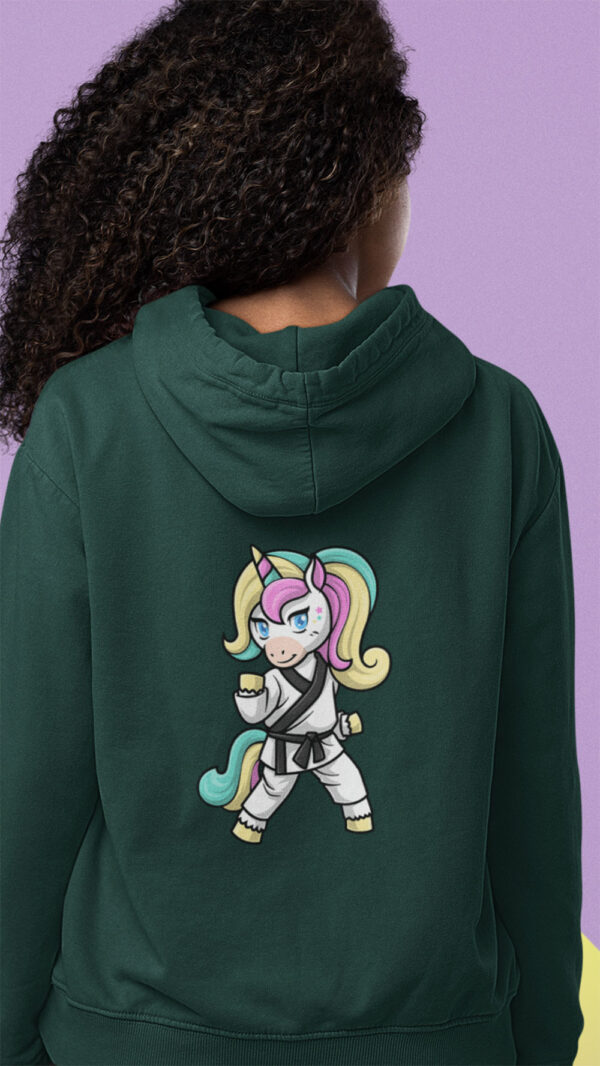 girl wearing green hoodie with karate unicorn art