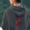 girl in grey hoodie with red dragon art