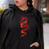 woman in black hoodie with red dragon art