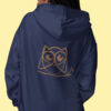 woman in blue hoodie with brown owl art