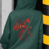women in green hoodie with red dragon art