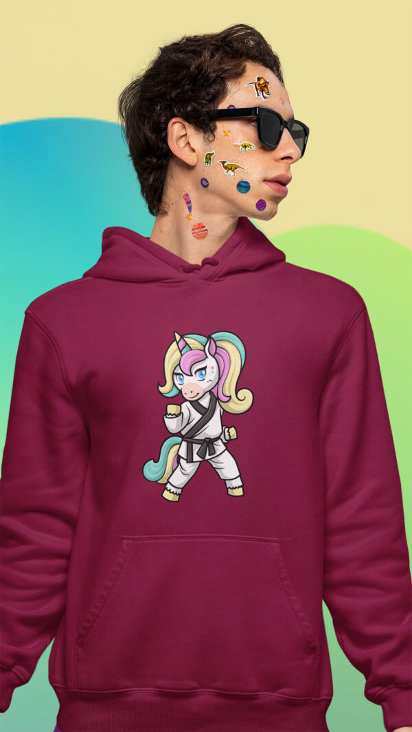 man wearing red hoodie with karate unicorn art and stickers on his face