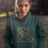 woman in green hoodie with brown owl art