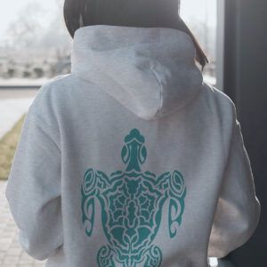 woman in white hoodie with green turtle art