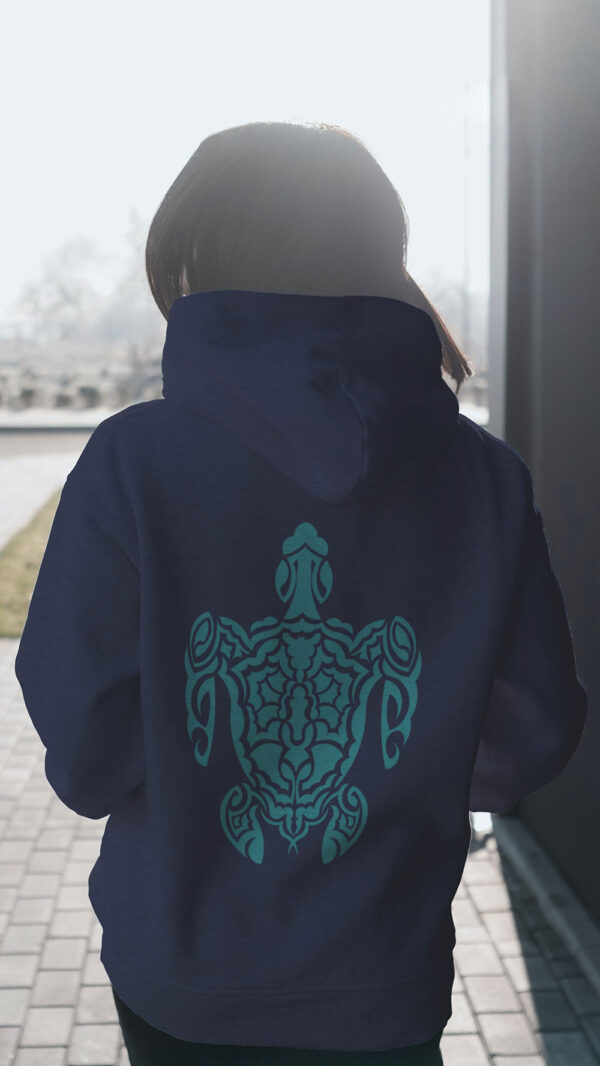 woman in blue hoodie with green turtle art