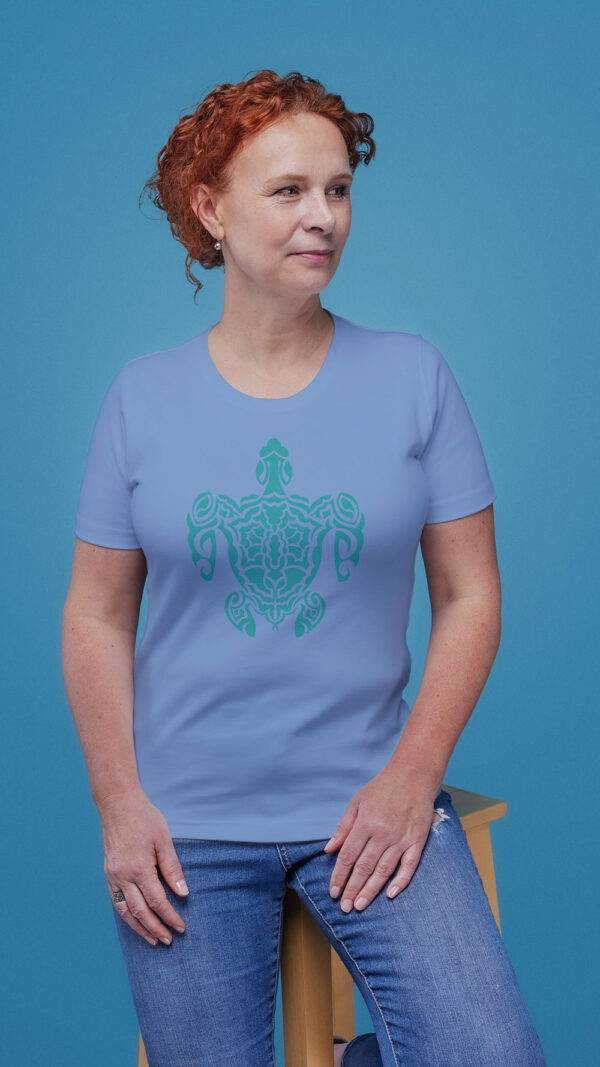 woman in blue shirt with green turtle art