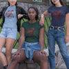 women in shirts with red dragon art