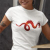 woman in white shirt with dragon art playing drums