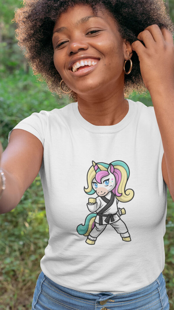 woman wearing white shirt with karate unicorn art