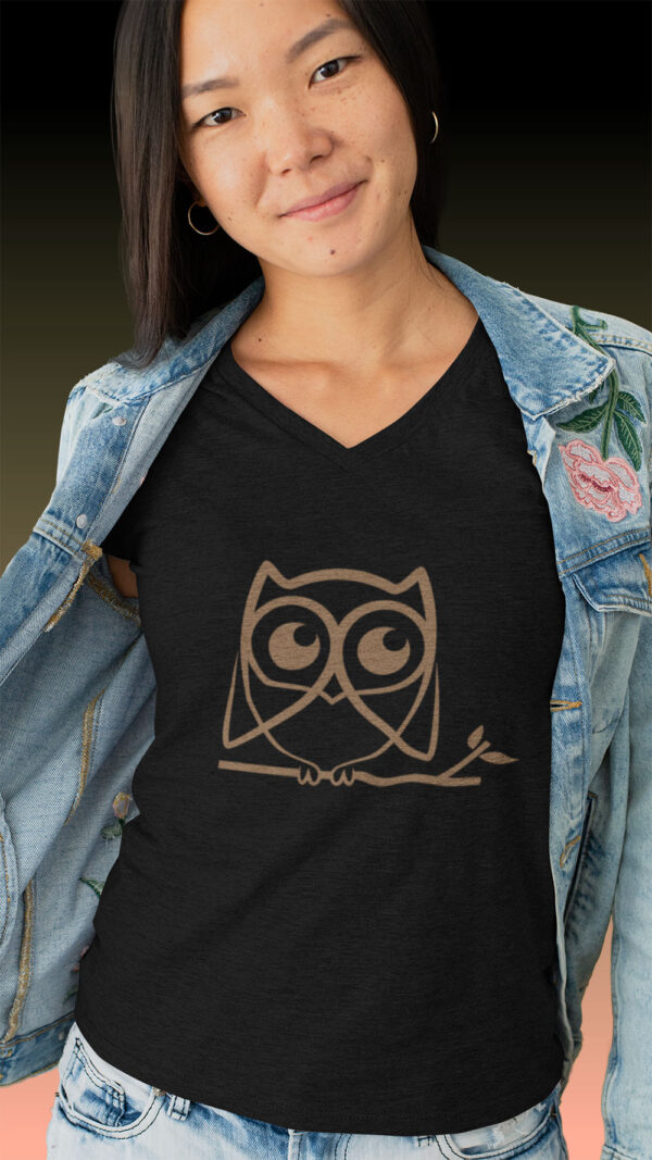 woman in black shirt with brown owl art