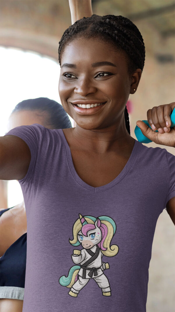 woman wearing purple shirt with karate unicorn art