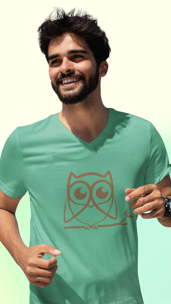 man in green shirt with brown owl art