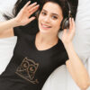 woman in black shirt with brown owl art with headphones