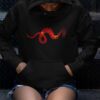 red dragon art on black hoodie on person