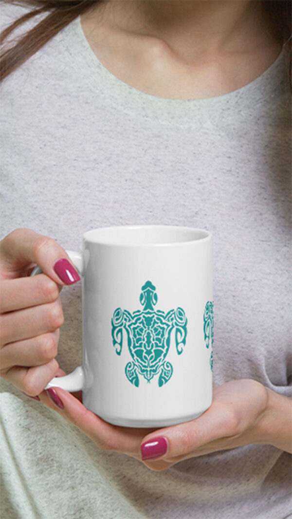Turtle image on mug in person's hands